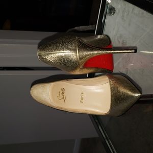 Christian Louboutin gold pumps